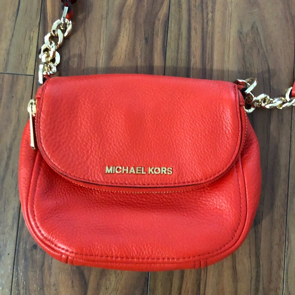 Orange Michael Kors fold over cross body purse